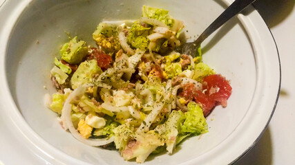 Bowl with salad garnished with oregano