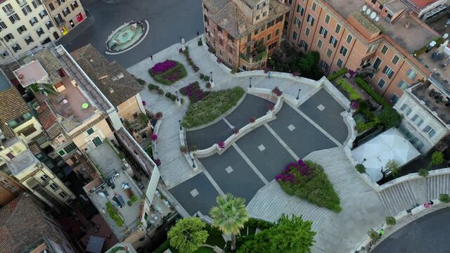 Piazza di Spagna in Rome, The Spanish Steps with flowers. Trinità dei Monti. Spectacular aerial drone shot of flower covered stairway on a spring day.