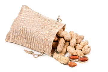 Heap of peanuts in textile bag isolated on a white background. Top view.