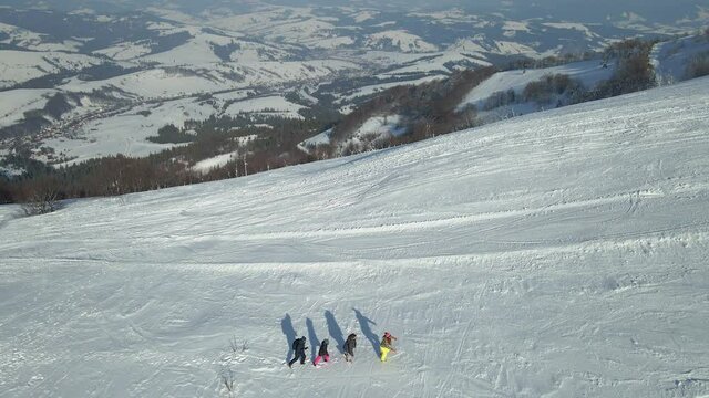 Tourists climb to the top of the mountain. Aerial view.
