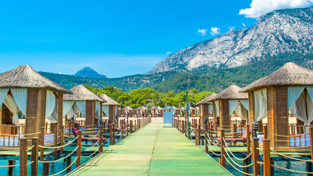 Wooden beach pavilions on the shore of a sandy beach