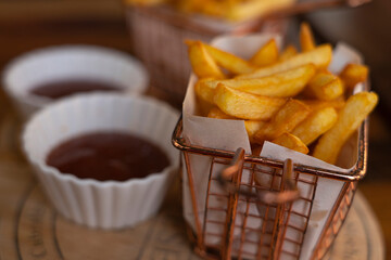 French fries are on the table against the background of sauce