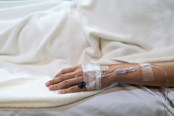 Patient hand close up with saline in hospital ward