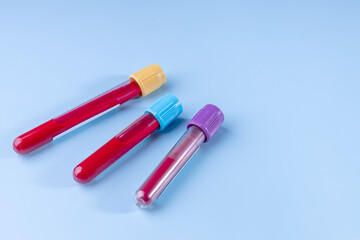 laboratory test tubes with blood for analysis on a blue background