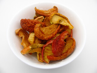Cut into pieces dried apples in a white bowl