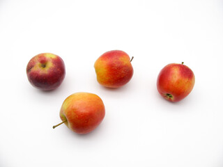 Four fresh juicy apples on a white background.