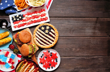 Fourth of July, patriotic, American themed food. Top view side border on a dark wood background....