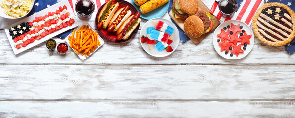 Fourth of July, patriotic, American themed food. Above view top border on a white wood banner background. Copy space. - obrazy, fototapety, plakaty