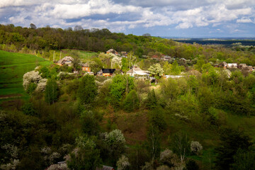 Ukrainian village, spring hills, houses and forest
