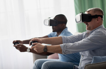 Friends play in video games together at home, having fun