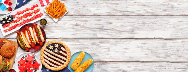 Fourth of July, patriotic, American themed food. Above view corner border on a white wood banner...