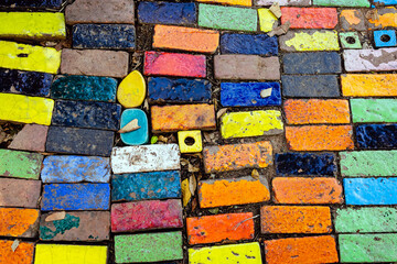 Top view on pieces of multicolored ceramic tiles decorated in garden. Old pavement of tiles textured. Street mosaic cobblestone sidewalk. Abstract,background and pattern of ceramic tile on the floor.