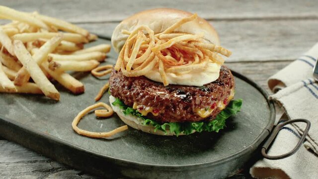 Cheese Stuffed Hamburger near French Fries on Antique Rustic Platter 