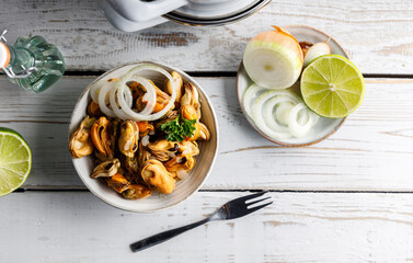 Mussels marinated in vinegar. Seafood appetizer fresh mussels marinated in vinegar and onions in a bowl. Top down view.