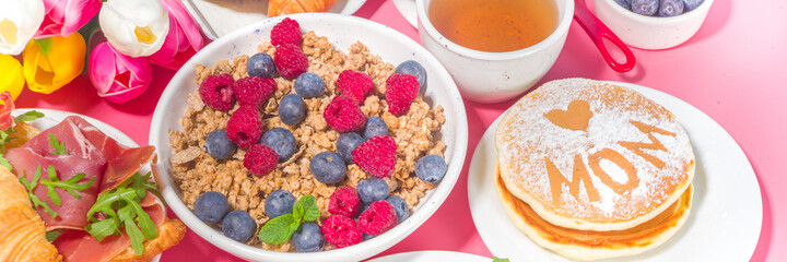 Mothers day Brunch restaurant invitation concept. Various Moms Womans Day Menu background, with traditional breakfast and lunch food and drink set, with flowers on sunny pink background