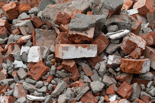 The background is the texture of the wreckage of old red brick and pieces of destroyed cement. A pile of construction debris for the whole picture. High quality photo