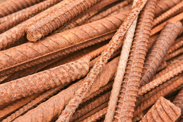 rusty reinforcing bars piled in a heap close-up