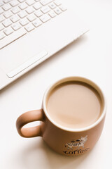 office desk, laptop with coffee mug, coffee mug on white background 