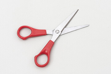 Red scissors isolated on white background.