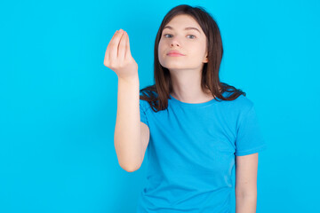 young beautiful Caucasian woman wearing blue T-shirt over blue wall Doing Italian gesture with hand and fingers confident expression - obrazy, fototapety, plakaty