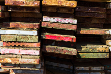 A close up on a pile of scaffold boards ends