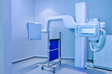 Equipment X-ray equipment in modern hospital. Modern x-ray machine and Computerized Axial Tomography scanning in hospital. X-ray room in a hospital operating room with a classic ceiling-mounted x-ray