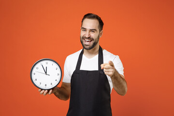 Young man barista bartender barman employee wear black apron white t-shirt work in coffee shop hold...