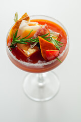 Bloody Mary with interesting decoration with a small snack on top of a cocktail glass