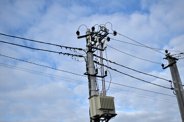 A concrete support with electrical wires attached to it.