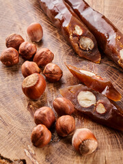 Churchkhela, composition from Georgian homemade sweets and nuts on wooden background