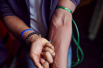 Drug addict man with syringe takes a dose