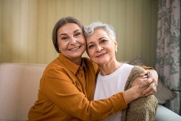 Family, age and mature people concept. Portrait of two joyful elderly sisters with wrinkles and...