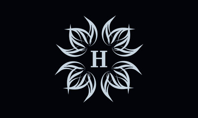 Vintage exquisite floral monogram with the letter H as a sign of business, boutique, shop, cafe, hotel, etc. Gray sign on a dark background