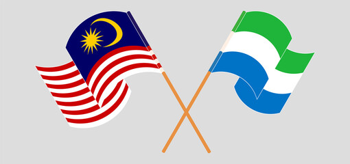 Crossed and waving flags of Malaysia and Sierra Leone