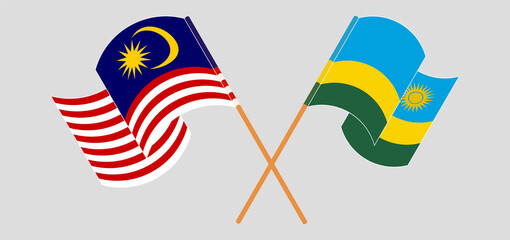 Crossed and waving flags of Malaysia and Rwanda