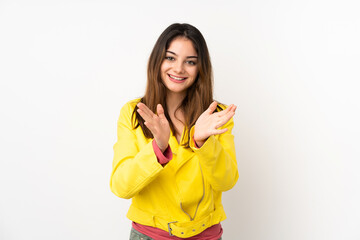 Young caucasian woman isolated on white background applauding after presentation in a conference