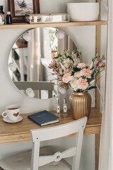 green spring bouquet on the table in interior. Celebration concept. Spring flowers. Light interior.