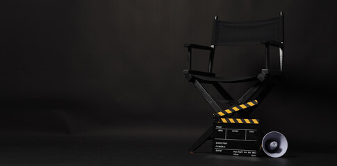 Black director chair and Clapper board or movie Clapperboard with yellow megaphone on black background.use in video production or film cinema industry