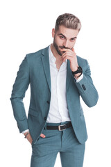 sexy young businessman in suit holding hand in pocket