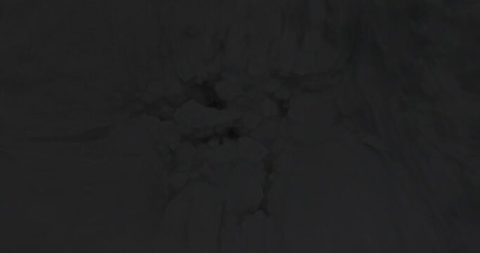 large explosion from dark smoke. powerful big bang and expanding fiery ball of fire over dark background.  dark smoke before fuel ignites into a large detonation. 