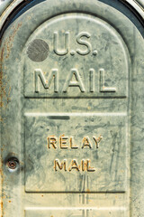 Old retro vintage mailbox box in green color with sign for relay mail vertical view closeup macro in St Augustine