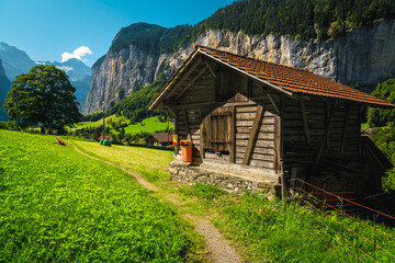 Wooden barn in the green field in Lauterbrunnen valley, Switzerland