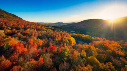 Fototapete Wasserfälle Aerial view of Mountain Forests with Brilliant Fall Colors in Autumn at Sunrise, New England  © heyengel