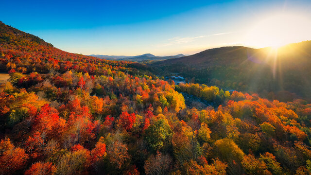 Aerial view of Mountain Forests with Brilliant Fall Colors in Autumn at Sunrise, New England