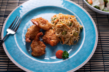 Crab cake with pasta and salad