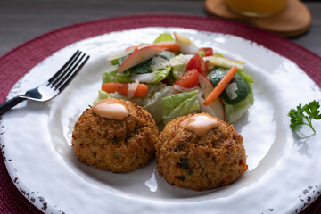 Crab cake with pasta and salad