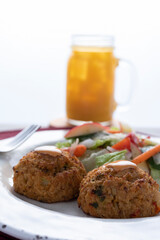 Crab cake with pasta and salad