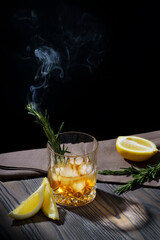 Whiskey cocktail with lemon and rosemary sprig