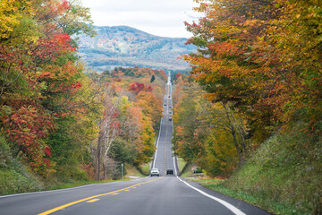 West Virginia road highway and many cars in traffic on autumn fall day near Blackwater Falls State park and Senca Rocks with steep hill - obrazy, fototapety, plakaty