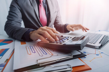 Business women working together at office desk, hands close up with calculator out financial data. teamwork workplace strategy Concept.